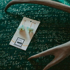 Light glowing blue sea glass minimalist threader earrings with brass wire