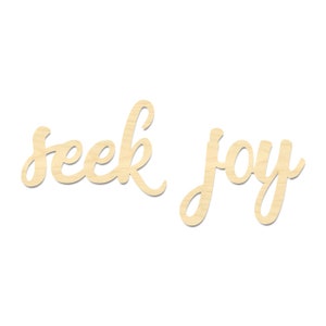 May include: Wooden sign with the words "seek joy" written in a cursive font.