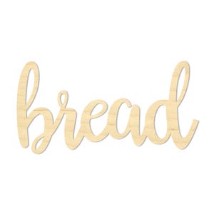 May include: A wooden sign in a cursive font that spells out the word "bread". The sign is made of light-colored wood and is set against a white background. The sign is a decorative item.