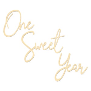 May include: Wooden sign with the text "One Sweet Year" in a cursive font.