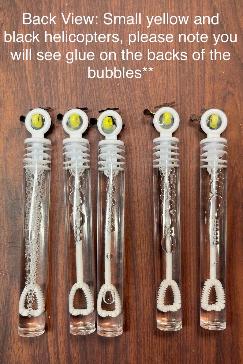 May include: Five clear plastic bubble wands with white caps and internal white wands. Each cap features a small yellow and black helicopter topper. Text reads: Back View: Small yellow and black helicopters, please note you will see glue on the backs of the bubbles**