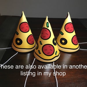 May include: Three yellow and red party hats shaped like pizza slices. Each hat has a green pepper, red pepper, and black olive on top. The hats are on a brown wooden surface. "These are also available in another listing in my shop" is written in white text at the bottom of the image.