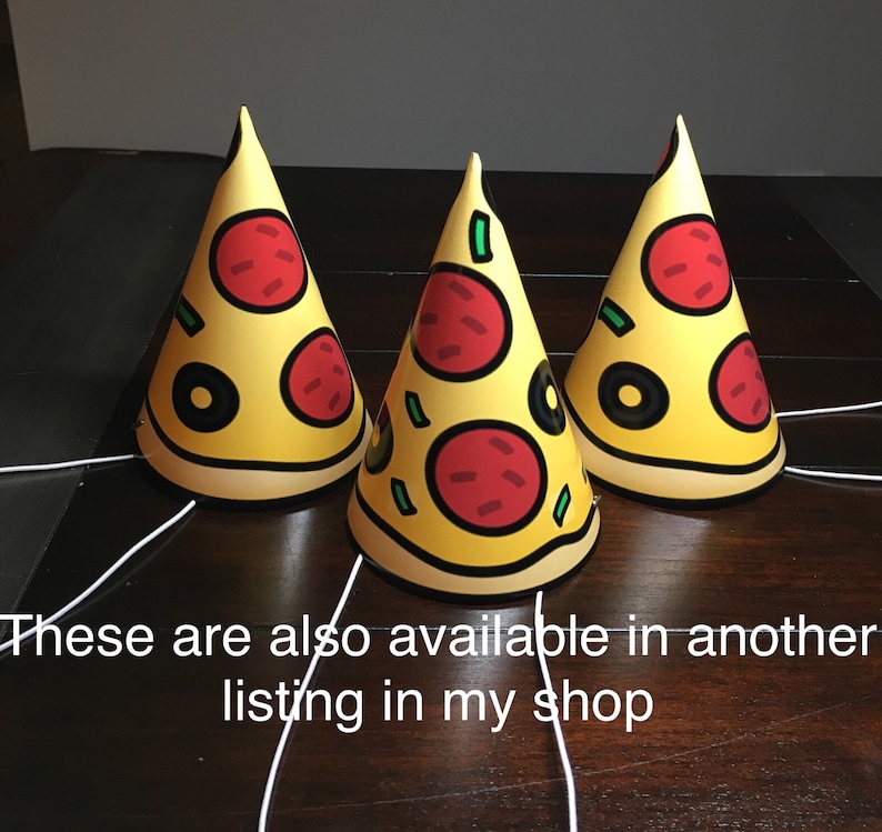 May include: Three yellow and red party hats shaped like pizza slices. Each hat has a green pepper, red pepper, and black olive on top. The hats are on a brown wooden surface. "These are also available in another listing in my shop" is written in white text at the bottom of the image.