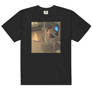 May include: Black t-shirt featuring a digital art print. The print depicts a person in a white dress sitting at a computer with a burning object on the floor. The shirt has a classic crew neck and short sleeves.