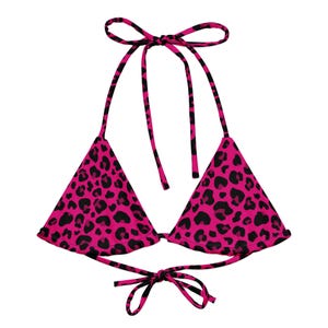 May include: A pink and black leopard print bikini top. The triangle-shaped top has black leopard spots on a bright pink background. The top ties at the neck and back with matching pink and black straps.