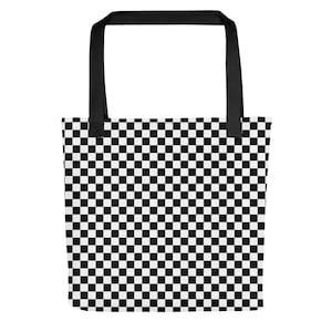 May include: A black and white checkered tote bag with black handles. The bag features a repeating pattern of black and white squares, creating a bold and graphic design. The tote bag is made of a durable material and is suitable for carrying various items.