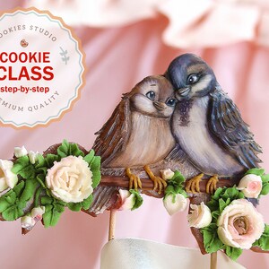 May include: Two brown and blue painted bird cookies perched on a branch with green leaves and pink roses. The cookies are decorated with details like eyes and feathers. The cookies are part of a "Cookie Class" set, which is described as "step-by-step, premium quality".