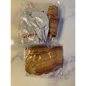 May include: A white ceramic mug adorned with a vibrant floral pattern. The mug has a handle and is designed for hot drinks. The floral design incorporates flowers and foliage in pinks, purples, and greens.