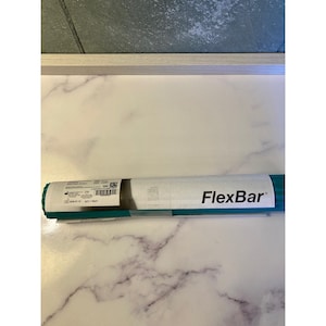 Puede incluir: Una herramienta de ejercicio FlexBar enrollada, principalmente verde azulado y blanca, descansa sobre una superficie de mármol. El FlexBar está etiquetado con el nombre del producto en texto negro. El embalaje incluye información del producto y un código de barras.