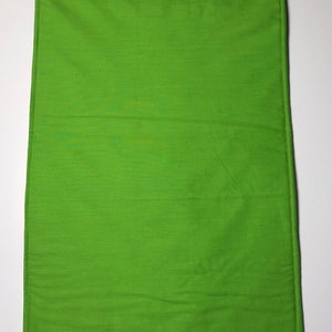 May include: A solid green rectangular fabric placemat with a stitched border.