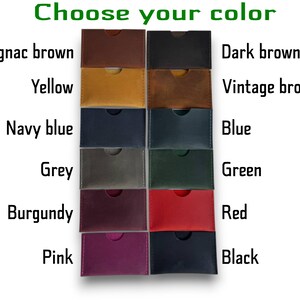 May include: A collection of twelve rectangular leather card holders arranged in two columns. The text "Choose your color" appears at the top, with labels for Cognac brown, Yellow, Navy blue, Grey, Burgundy, Pink, Dark brown, Vintage brown, Blue, Green, Red, and Black.
