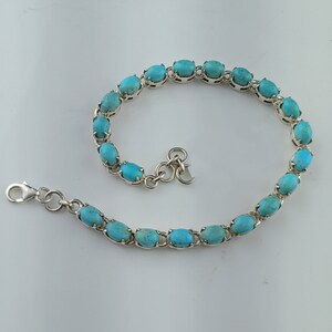 This beautiful tennis bracelet handmade of 925 sterling silver studded with prong set oval turquoise cabochon gemstone best gift for women and girls.