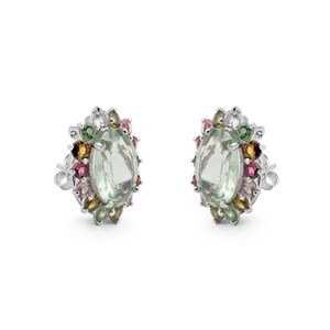 May include: A pair of silver earrings with a green oval gemstone surrounded by smaller multi-colored gemstones.