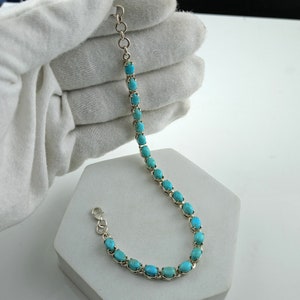 This beautiful tennis bracelet handmade of 925 sterling silver studded with prong set oval turquoise cabochon gemstone best gift for women and girls.