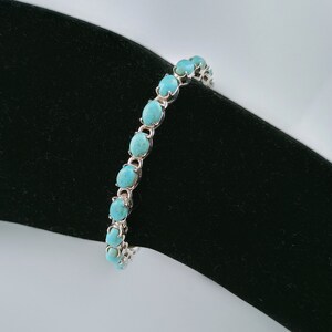 This beautiful tennis bracelet handmade of 925 sterling silver studded with prong set oval turquoise cabochon gemstone best gift for women and girls.