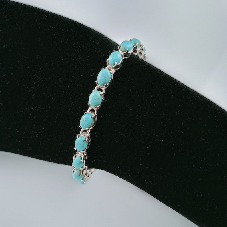 This beautiful tennis bracelet handmade of 925 sterling silver studded with prong set oval turquoise cabochon gemstone best gift for women and girls.