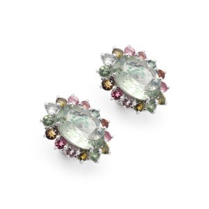 May include: A pair of silver earrings with a large oval green gemstone surrounded by a halo of smaller multi-colored gemstones.