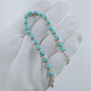 This beautiful tennis bracelet handmade of 925 sterling silver studded with prong set oval turquoise cabochon gemstone best gift for women and girls.