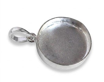 May include: A circular silver-toned metal pendant tray featuring a smooth, recessed center for inlay work and a small, integrated loop at the top for attachment to a chain or cord. The piece has a polished, reflective finish throughout.