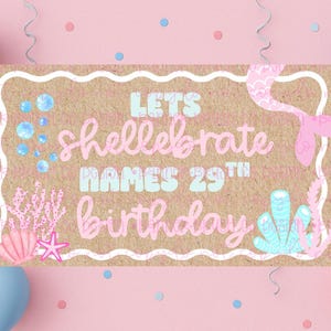 Peut inclure: Bannière d'anniversaire sur le thème des sirènes. La bannière indique "Lets shellebrate NAMES 29th birthday" en lettres roses et bleues. La bannière est entourée de ballons roses et bleus et de confettis sur fond rose.