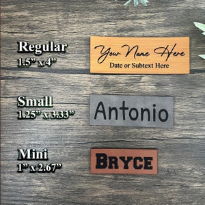 May include: Three leather name tags in different sizes: regular (1.5" x 4"), small (1.25" x 3.33"), and mini (1" x 2.67"). The regular tag is brown with the text "Your Name Here" and "Date or Subtext Here". The small tag is gray with the name "Antonio". The mini tag is brown with the name "BRYCE".