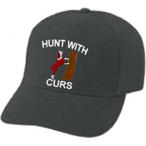 May include: A dark gray baseball cap with the words "HUNT WITH CURS" in white lettering. The cap features an embroidered design of a red dog and a brown tree trunk. The cap has a curved brim and a button on top.