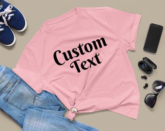 May include: A pink t-shirt with black text that says "Custom Text".
