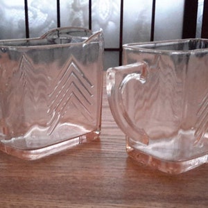 Peut inclure: Ensemble sucrier et crémier en verre transparent avec un motif géométrique. L'ensemble est en verre rose et a un aspect vintage.