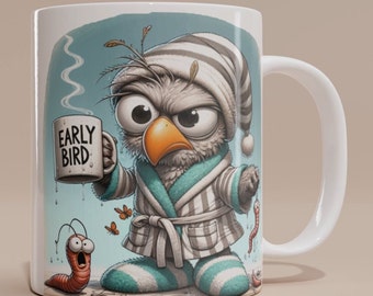 May include: White ceramic mug with a cartoon illustration of an owl wearing a sleep mask and a robe, holding a mug that says "Early Bird". The owl has a grumpy expression and is surrounded by small worms.