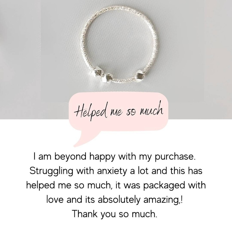 May include: A silver bracelet with three small, cube-shaped charms. The bracelet is on a white background. "Helped me so much" is written in a speech bubble.