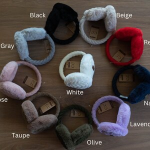 May include: Ten pairs of earmuffs in various colors, including black, beige, red, white, navy, lavender, rose, taupe, gray, and olive. The earmuffs are made of soft, fuzzy material and have a knitted headband.