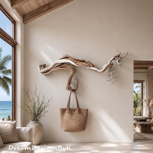 May include: A large, horizontal piece of natural driftwood mounted on a wall, functioning as a wall hook. A brown woven tote bag with leather handles hangs from the driftwood. The text DreamDesignsByK is visible in the bottom left corner.