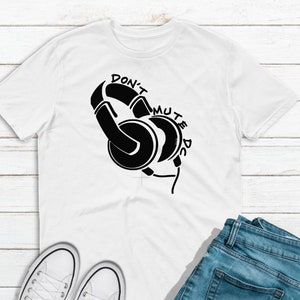May include: White t-shirt with a black graphic of headphones and the text "Don't Mute the DJ".