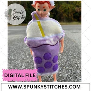 May include: A purple and white plush toy shaped like a boba tea cup with a straw. The toy has a white rim and a yellow straw. The cup has purple boba balls on the bottom. The toy is being held by a doll with red hair and elf ears. The text "DIGITAL FILE" is on a pink banner at the bottom of the image. The text "WWW.SPUNKYSTITCHES.COM" is on a white banner at the bottom of the image.