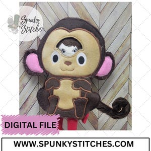 May include: A plush monkey toy with a light brown face, dark brown details, and pink ears. A small face is visible in the center. The text "DIGITAL FILE" is on a pink banner. The website address is www.spunkystitches.com.