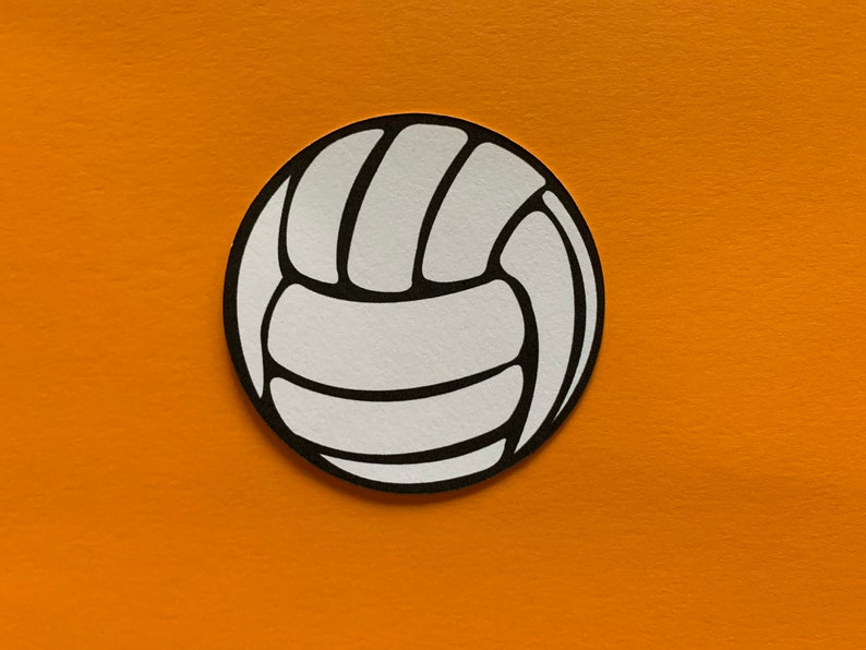May include: A white volleyball with black outlines, set against an orange background. The ball's design features the classic segmented panels, creating a circular shape. The image is a simple, clean graphic.