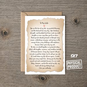 May include: A 5x7 greeting card with a tan, parchment-style paper overlay featuring a deckled edge. The card displays black printed text that reads To My Wife, followed by a heartfelt message and a small red heart icon, paired with a brown envelope.