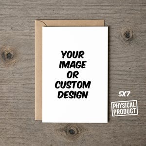 May include: A white rectangular greeting card with a brown envelope. The card features the black text "YOUR IMAGE OR CUSTOM DESIGN" and a small white label with the black text "5X7 PHYSICAL PRODUCT" indicating the dimensions in inches.
