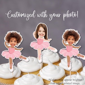 May include: Cupcake toppers featuring a ballerina design with a photo. The toppers are in the shape of a ballerina wearing a pink tutu and ballet shoes. The text "Customized with your photo!" is written above the toppers.