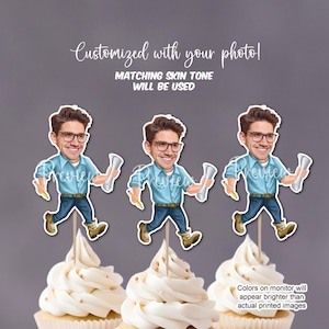 May include: Three cupcake toppers featuring cartoon illustrations of people holding blueprints. The toppers are on top of white cupcakes with gold sprinkles. The text "Customized with your photo! Matching skin tone will be used" is at the top of the image. The text "Colors on monitor will appear brighter than actual printed images" is at the bottom of the image.