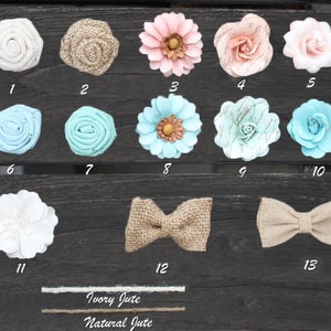 May include: Assortment of fabric flowers in various colors and styles, including white, pink, blue, and green. There are also two burlap bows and two spools of jute twine labeled "Ivory Jute" and "Natural Jute".