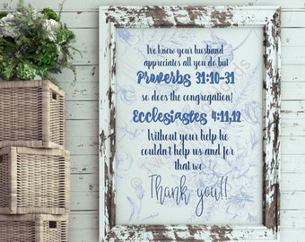 May include: A framed print with a distressed white frame, featuring blue floral illustrations and text. The text includes Bible verses from Proverbs and Ecclesiastes, along with the words "Thank you!!". The print is displayed on a white wooden wall.