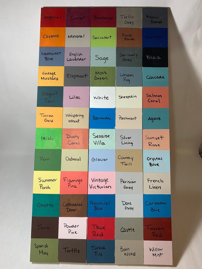 May include: A wooden color chart featuring a grid of painted squares, each labeled with a unique color name. Colors range from Imperial red to Willow Mist, showcasing a variety of hues for design inspiration. The chart is displayed on a white surface.