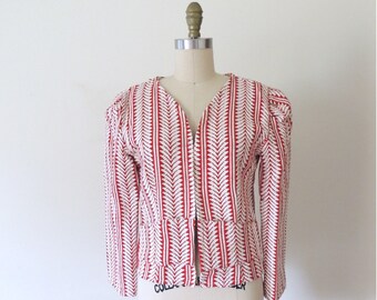 May include: A red and white striped blazer with a zipper closure. The blazer has a V-neck and a fitted silhouette.