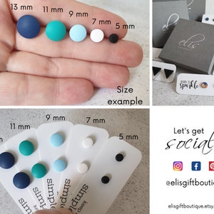 May include: A set of six pairs of round, polymer clay earrings in various colors and sizes, including navy blue, teal, light blue, white, and black. The earrings are displayed on a white card with the size of each pair listed in millimeters. The card also includes the text "Keep it simple".
