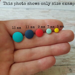 May include: Five round, colorful polymer clay earrings in different sizes. The earrings are 13 mm, 11 mm, 9 mm, 7 mm, and 5 mm in diameter.