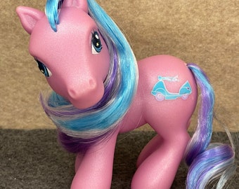 May include: A pink My Little Pony with blue and purple hair. The pony has a blue and white car symbol on its flank.