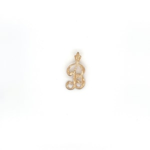 May include: Gold-toned pendant charm in the shape of the letter B. The letter is in a cursive script style.