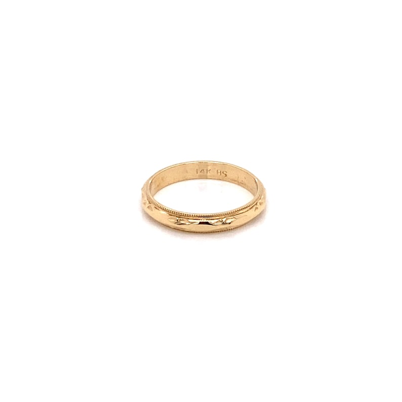 May include: A simple gold wedding band with a textured design. The band is marked "14K HS".