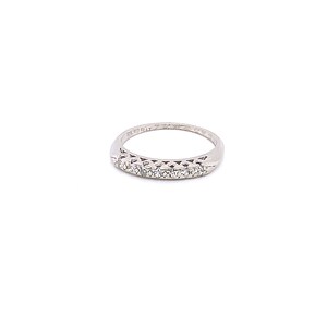 May include: A silver band with a row of small diamonds set in a half-round design.